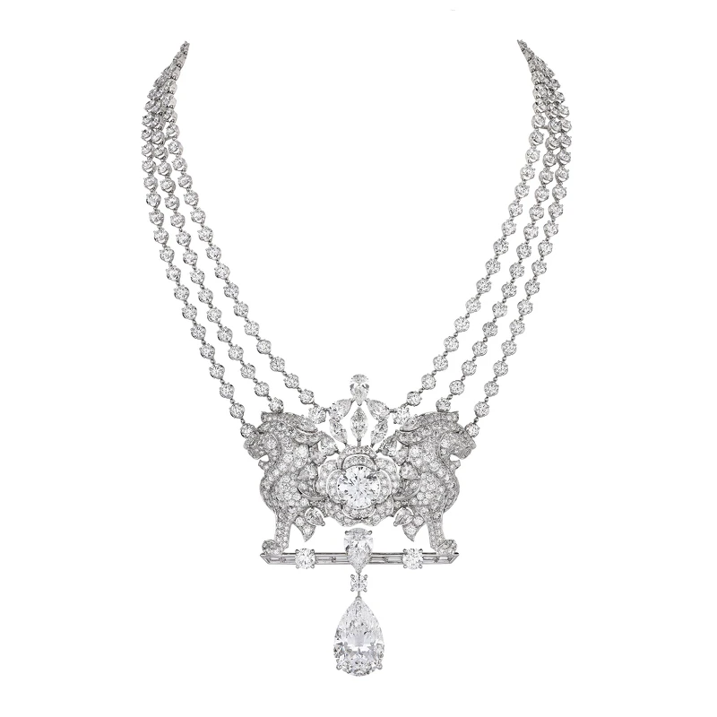 項鍊結合獅子和山茶花兩大品牌標記 ，同時展現女性力量與柔美特質。項鍊墜飾的梨形主鑽為可拆卸式設計，亦可組裝於套組的戒指佩戴。品牌非凡工藝使工作室在創作珠寶時可盡情發揮創意，不需採用一般標準的梨形切割鑽石，而是得以因應設計需求而去選擇優良品質鑽石，進而考量切割方式。此珠寶套組的項鍊與耳環中，便採用「垂墜」效果較為明顯的細長式梨形切割鑽石。創意，始終是香奈兒頂級珠寶的核心所在。 LION SECRET DIAMANT 可拆卸式項鍊 （獨一無二作品，全系列中單價最高之作） 18K白金，鑲嵌1顆重約15.55克拉DF L Type IIa梨形切割鑽石、1顆重約5.29克拉DI F Type IIa明亮式切割鑽石、2顆重約0.80克拉VVS明亮式切割鑽石及鑽石。 建議售價NTD 184,787,000元