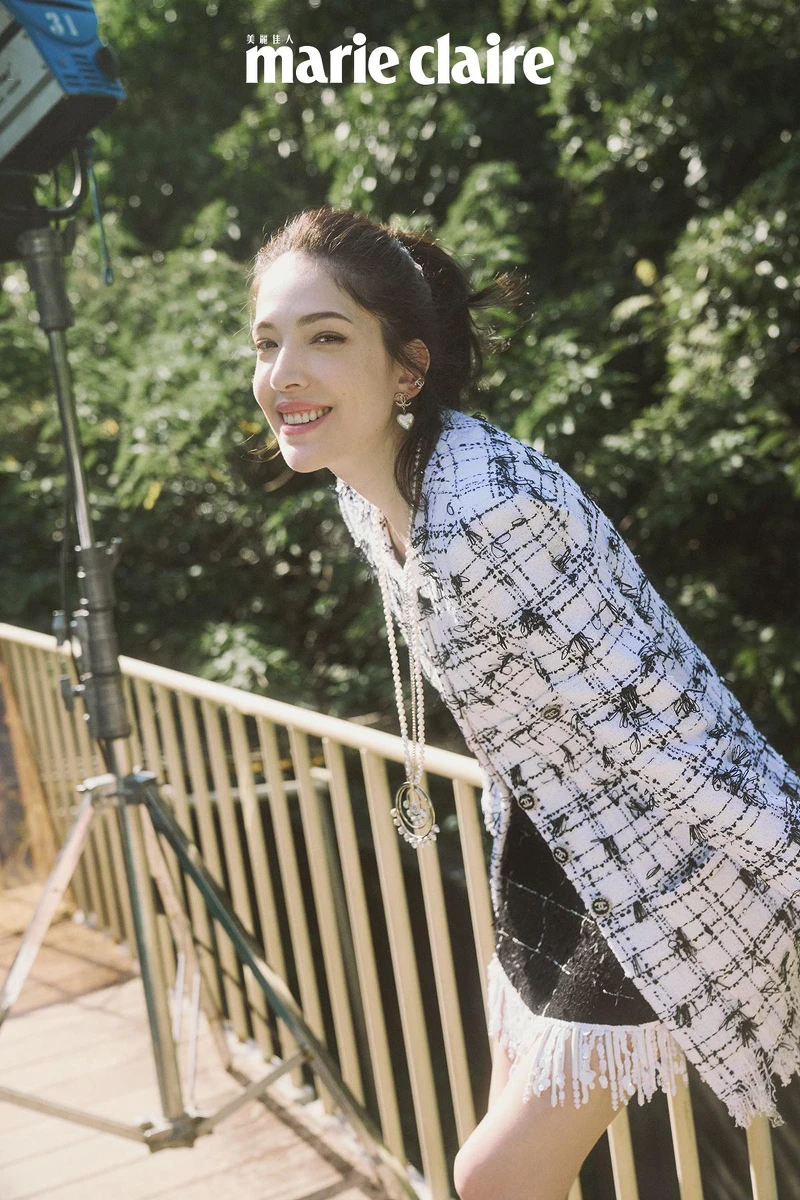 黑白流蘇造型斜紋軟呢外套與同款黑色及膝裙、金色皮革械型雙色瑪莉珍鞋、金屬高級樹脂愛心造型耳環、黑色漆皮械型短靴與可拆式白色襪套，all by CHANEL。