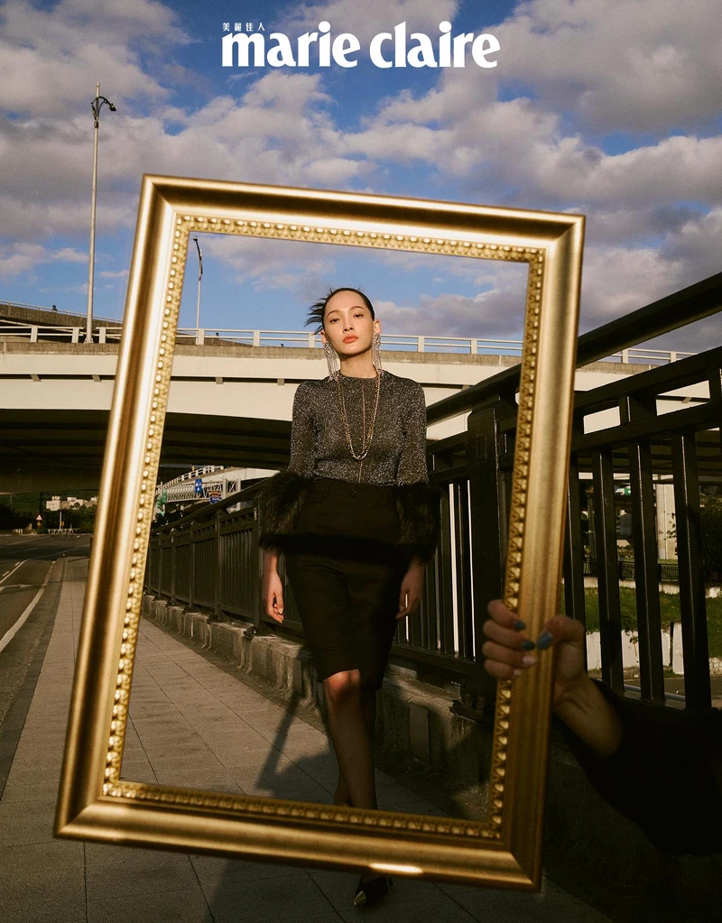 黑色毛袖上衣、黑色短褲、鑽飾流蘇耳環、金銀項鍊，all by Saint Laurent。