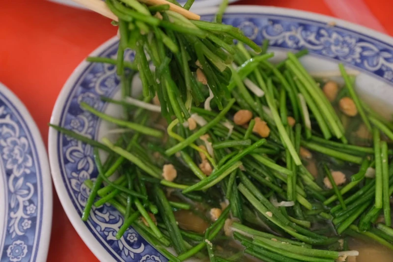 以黃豆醬、薑絲拌炒水蓮。 以黃豆醬、薑絲拌炒水蓮。