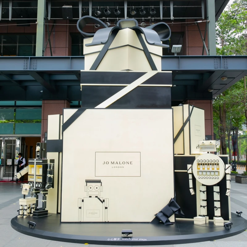 生動有趣的機器人JoBots出現在大型品牌奶油色禮物盒上頭，驚喜現身於新光三越台中中港店大門口，化身為Jo Malone London迎賓大使歡迎大家。