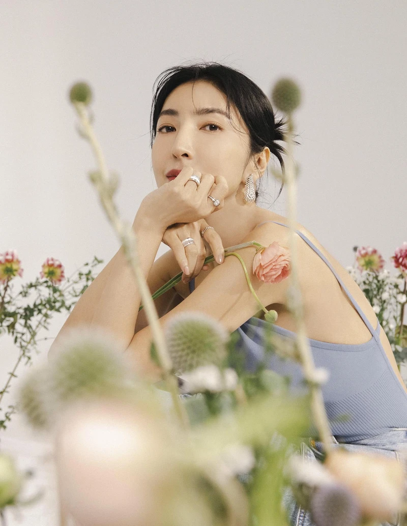 牛仔雙口袋工作褲，Sandro；水藍針織露背連身衣、水藍長大衣，both by Max Mara；Plume de Paon 鑽石耳環、Quatre戒指、Plume de Paon 戒指、Liseré戒指，all by Boucheron。