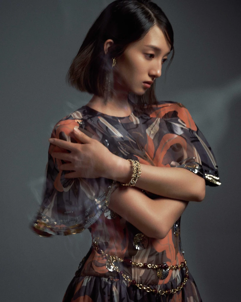 亮片刺繡裝飾絲質印花斗篷與洋裝、金屬與琉璃珠腰鍊、手環、金屬長形耳環，all by CHANEL。