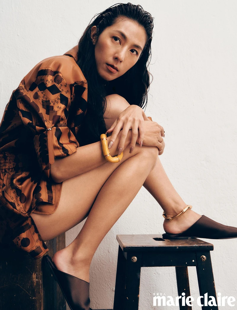 栗棕色斜紋真絲連身短褲,Hermès;Alba 緞面平底拖鞋,Loro Piana;金色臂環、綠色手環,both by Gucci。  栗棕色斜紋真絲連身短褲,Hermès;Alba 緞面平底拖鞋,Loro Piana;金色臂環、綠色手環,both by Gucci。