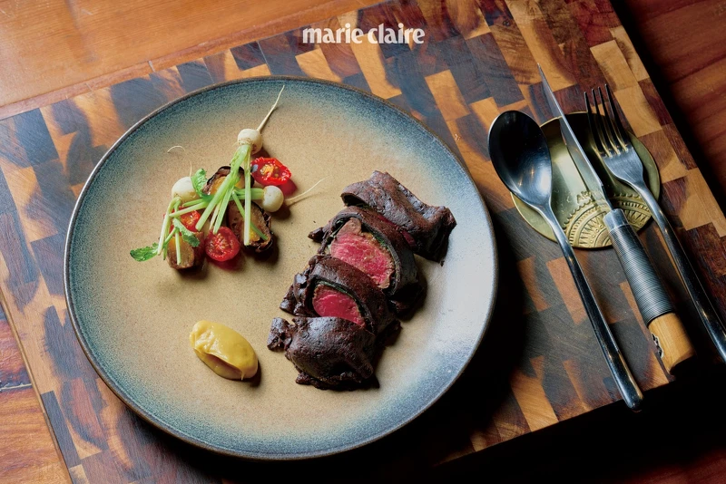 主菜「鹿肉|大葉胡椒|巧克力」,以直火烤製鹿肉後塗上自製、以樹豆發酵的味噌,外層再包裹上臺灣原生種大葉胡椒葉,帶有花香、柑橘的甜味,以及可可皮,最後搭配上風味醇厚的巧克力醬汁,襯托出鹿肉的圓潤迷人的風味。 主菜「鹿肉|大葉胡椒|巧克力」,以直火烤製鹿肉後塗上自製、以樹豆發酵的味噌,外層再包裹上臺灣原生種大葉胡椒葉,帶有花香、柑橘的甜味,以及可可皮,最後搭配上風味醇厚的巧克力醬汁,襯托出鹿肉的圓潤迷人的風味。