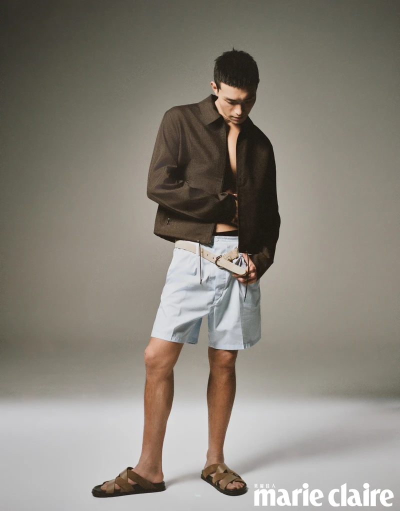 深褐色夾克上衣、藍色短褲，all by Prada；皮革涼鞋、印花絲巾，all by Hermès；戒指，Celine。